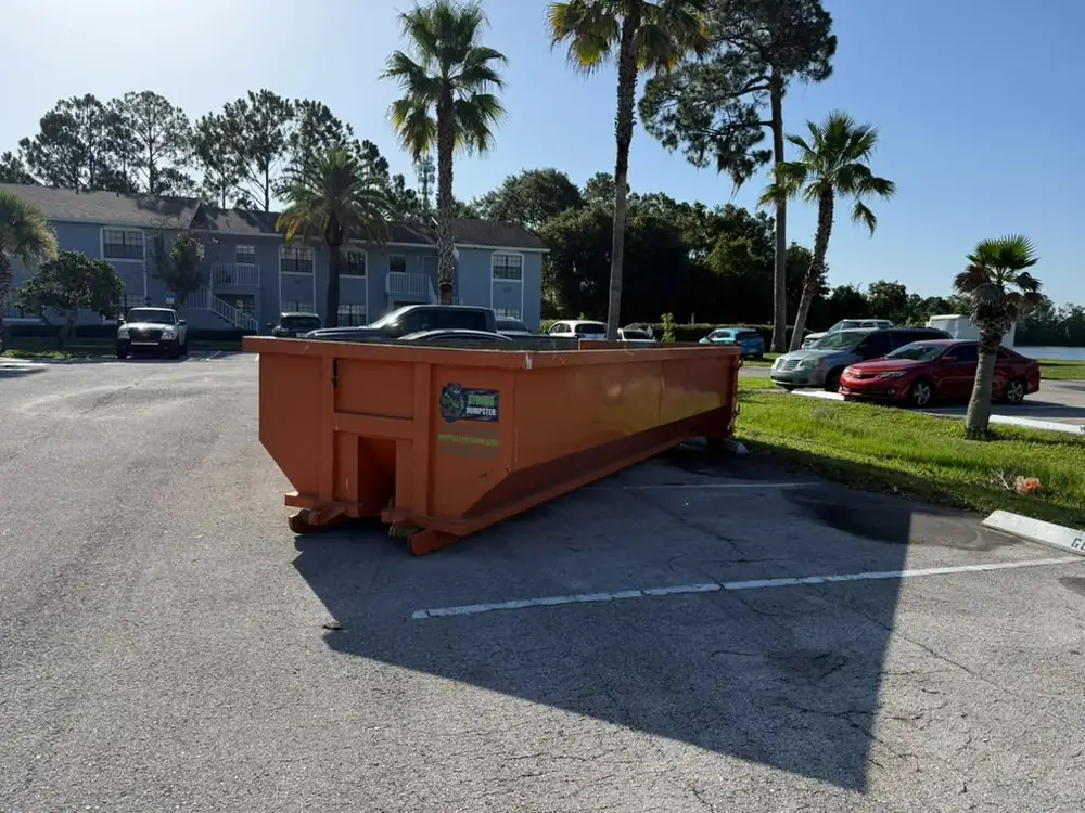 Roll-off dumpster in an Orlando apartment community parking lot