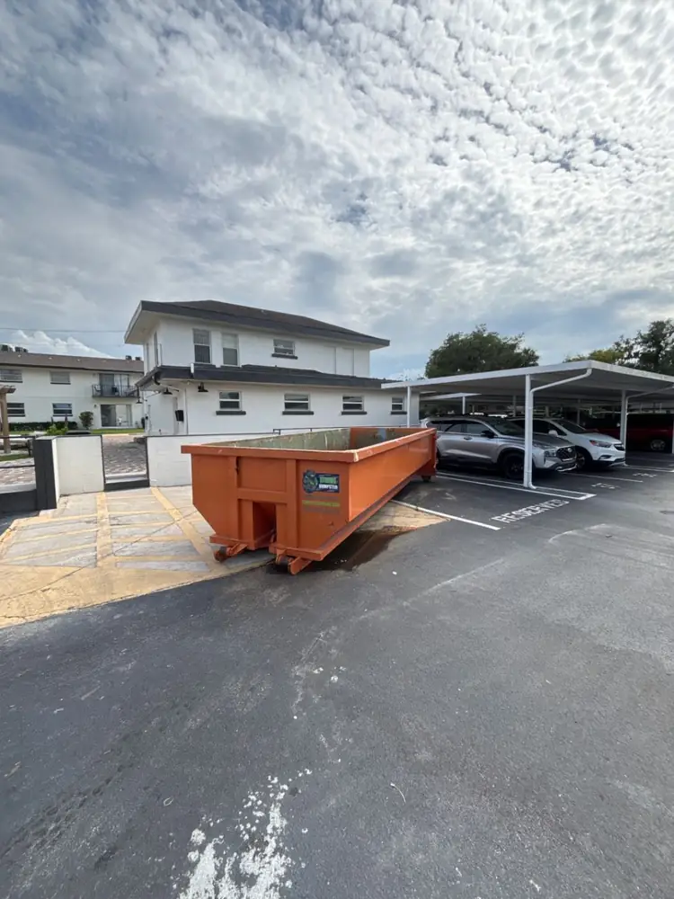 Dumpster Strong roll-off dumpster in a Cranes Roost Altamonte Springs FL apartment community parking lot for a unit make-ready turnover