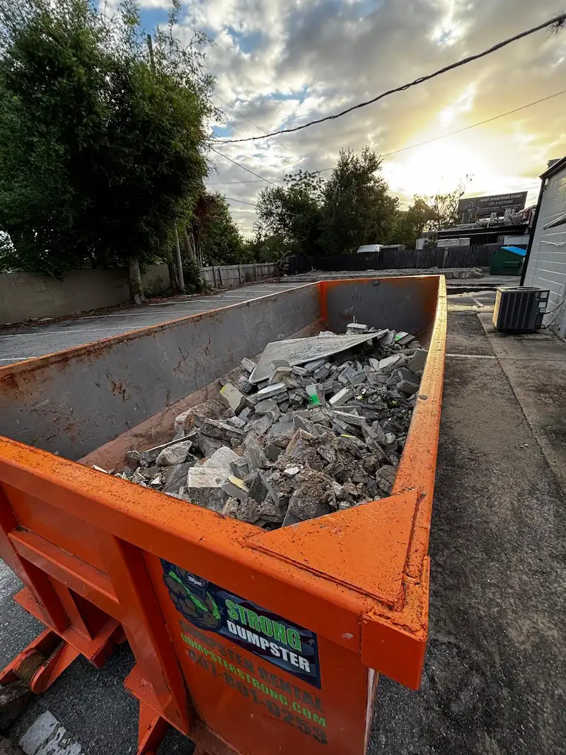 Dumpster Strong 20-yard concrete dumpster loaded with broken concrete