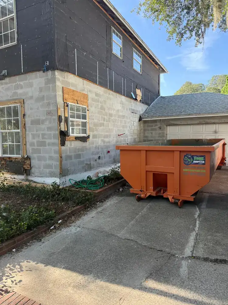 Construction dumpster at a home-addition project like the builds running across Horizon West Winter Garden FL