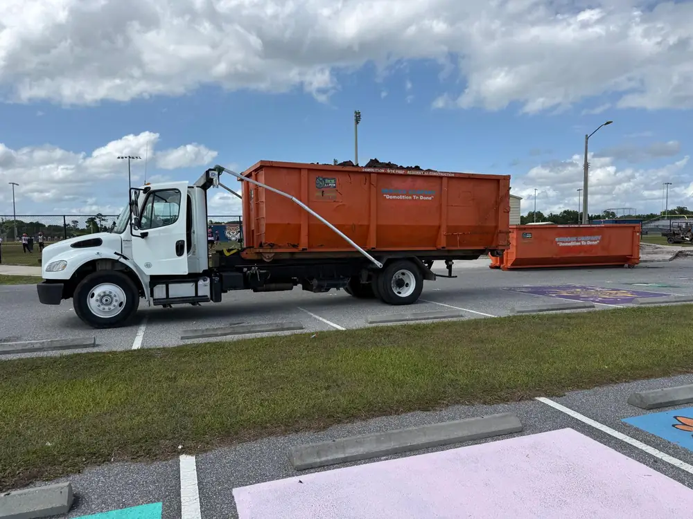 Loaded Dumpster Strong roll-off on the truck headed to disposal, full tear-out haul-off service for Oviedo FL projects
