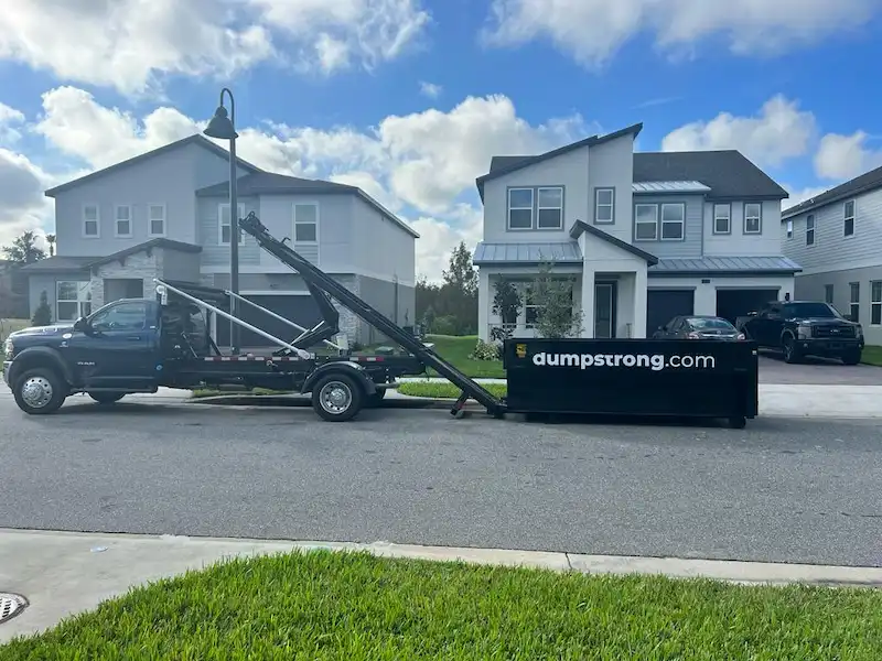Dumpster Strong truck delivering a dumpster in a neighborhood near Clermont, FL