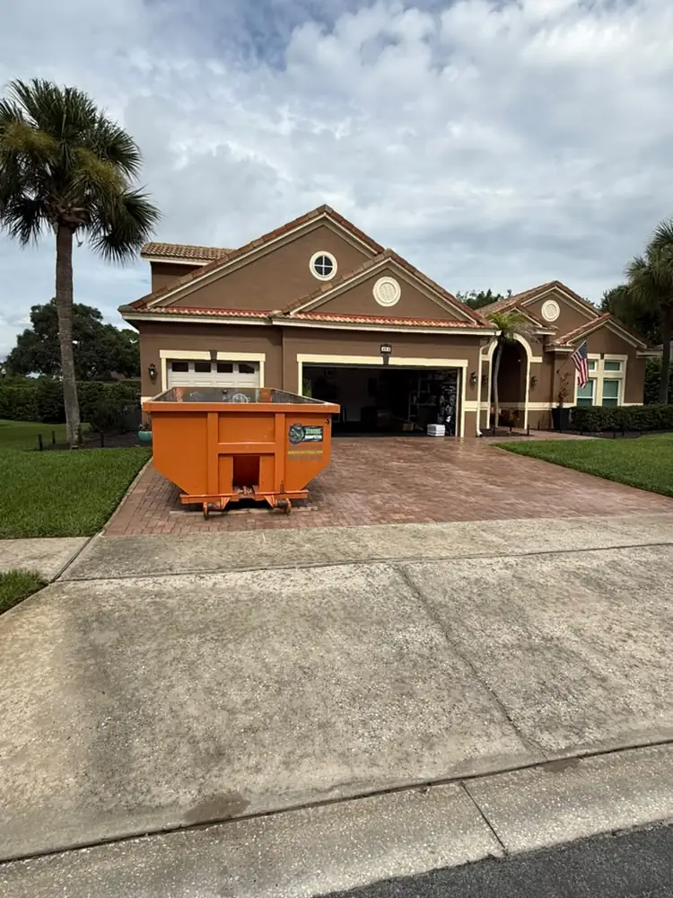 Roll-off dumpster at a tile-roof estate near Bay Hill, Dr. Phillips Orlando