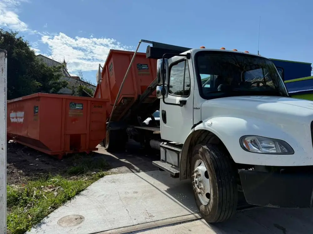 Dumpster Strong roll-off truck delivering a dumpster, same-day service to Maitland FL and the Orlando area