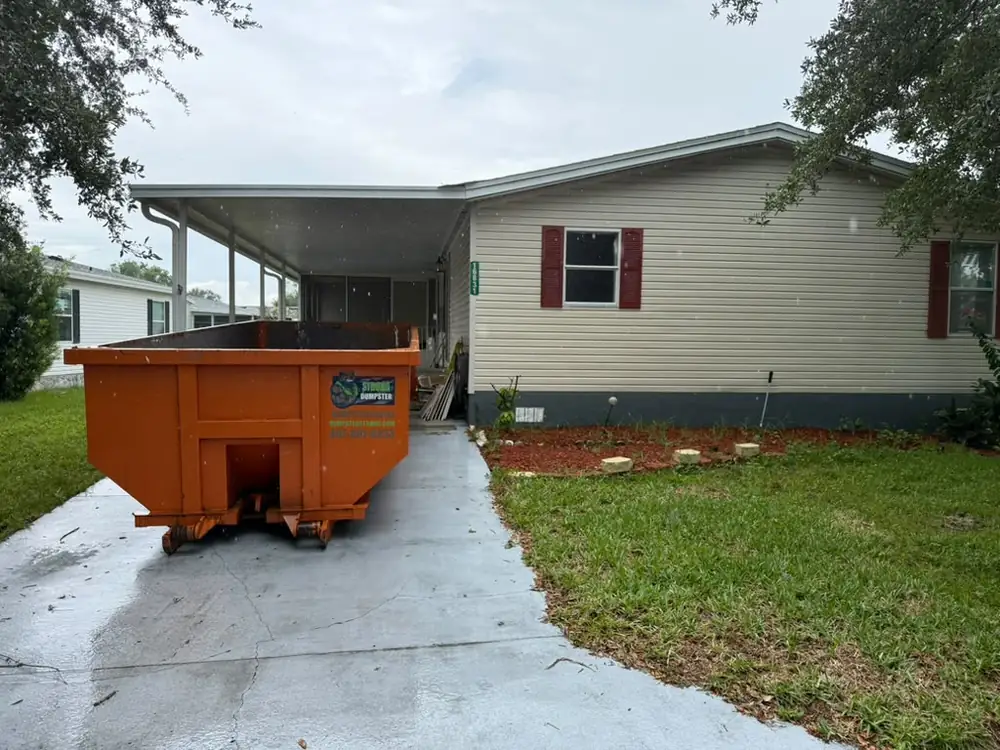 Roll-off dumpster on a mobile home driveway in St. Cloud FL