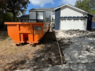 Construction dumpster loaded with concrete in Orlando