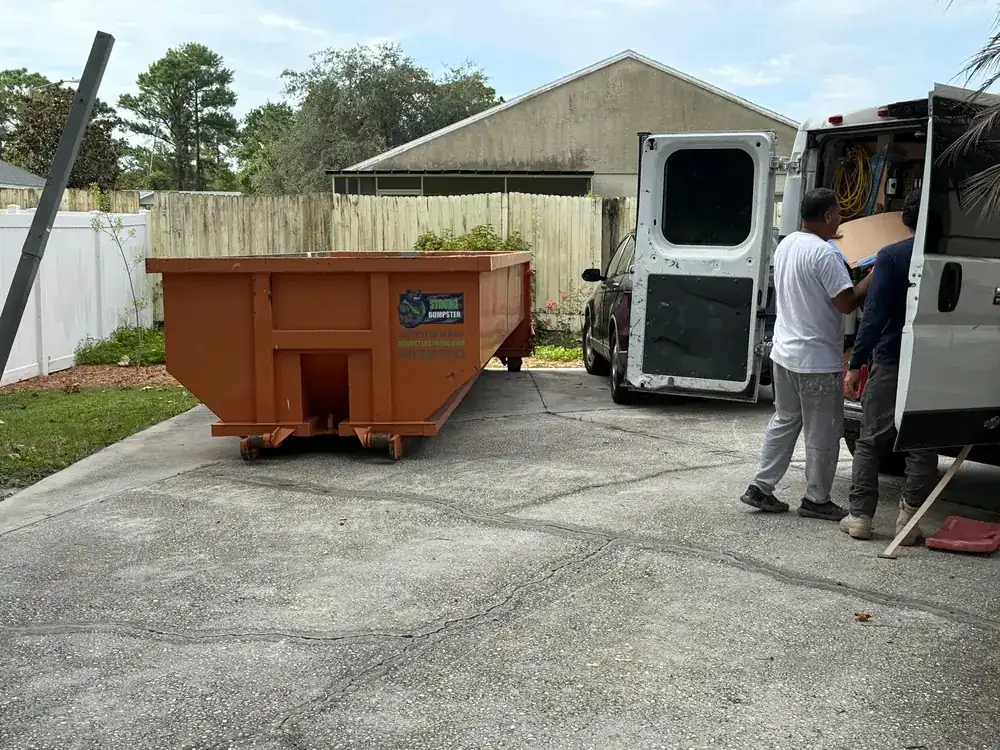Dumpster and moving van during an estate cleanout at a Central Florida home
