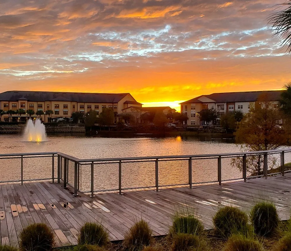 Oviedo on the Park lake at sunset — a community Dumpster Strong serves daily