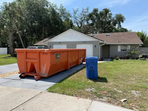 Roll-off dumpster rental delivered to an Oviedo FL residential driveway