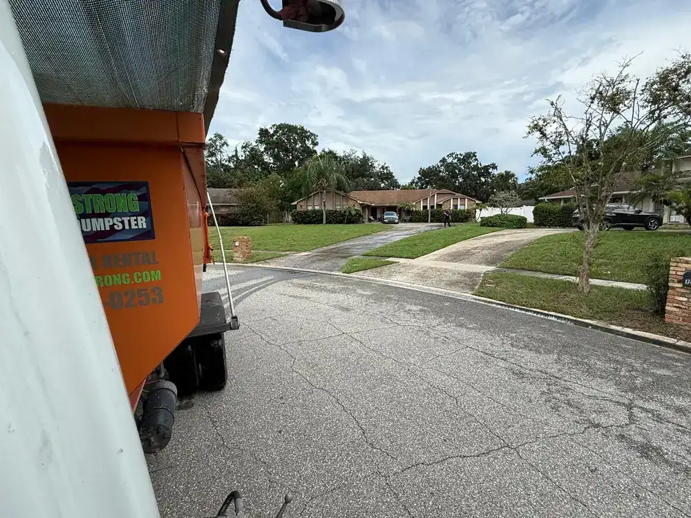 Dumpster Strong truck making a same-day dumpster delivery in an Orlando neighborhood
