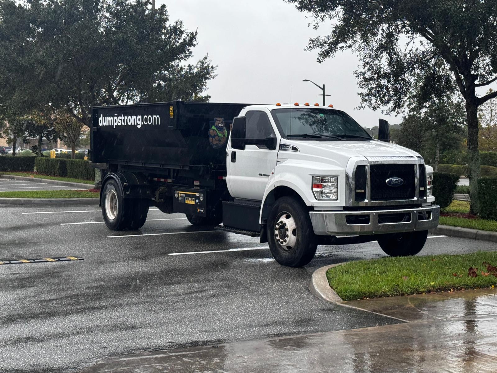 Dumpster Strong truck delivering dumpster in Orlando