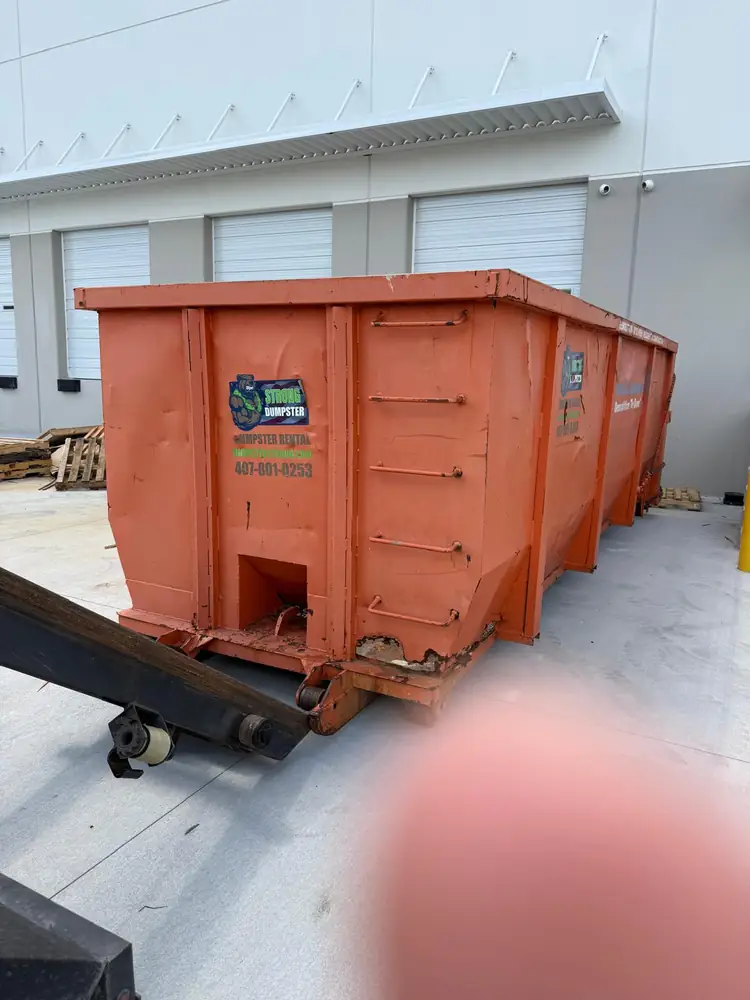 Roll-off dumpsters at an Orlando warehouse loading dock