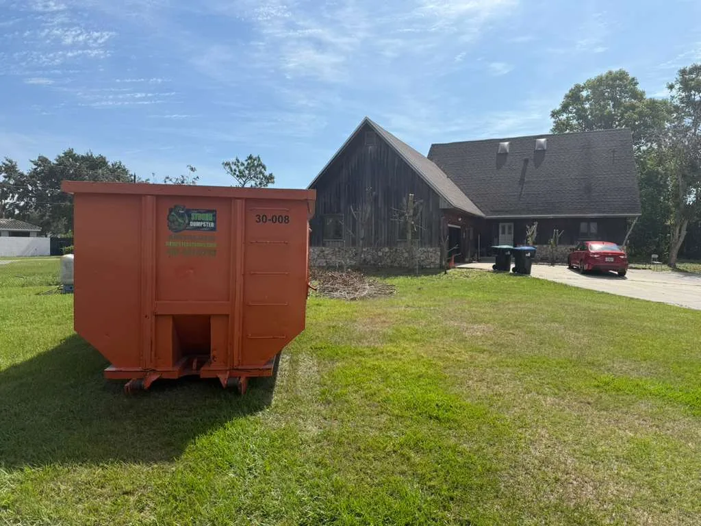 30 yard Dumpster Strong roll-off container on a residential lawn in Winter Park FL