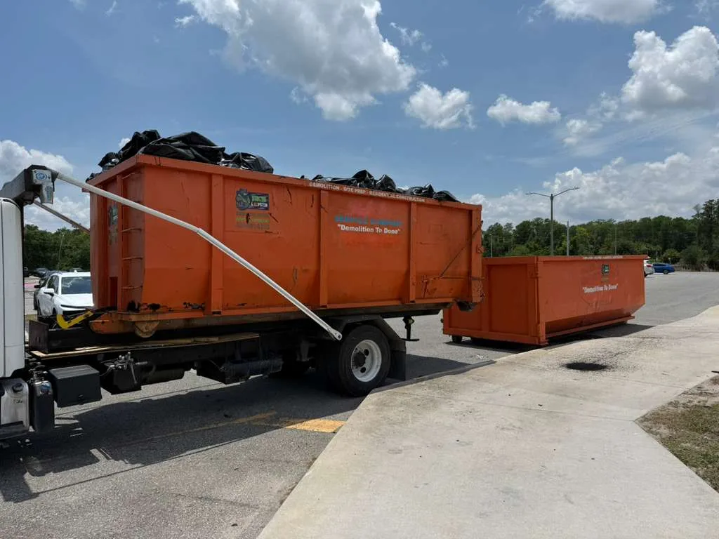 Dumpster Strong roll-off truck delivering a roll-off dumpster in Winter Park FL