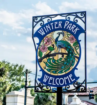 Welcome to Winter Park FL peacock sign — Dumpster Strong serves the entire Winter Park community